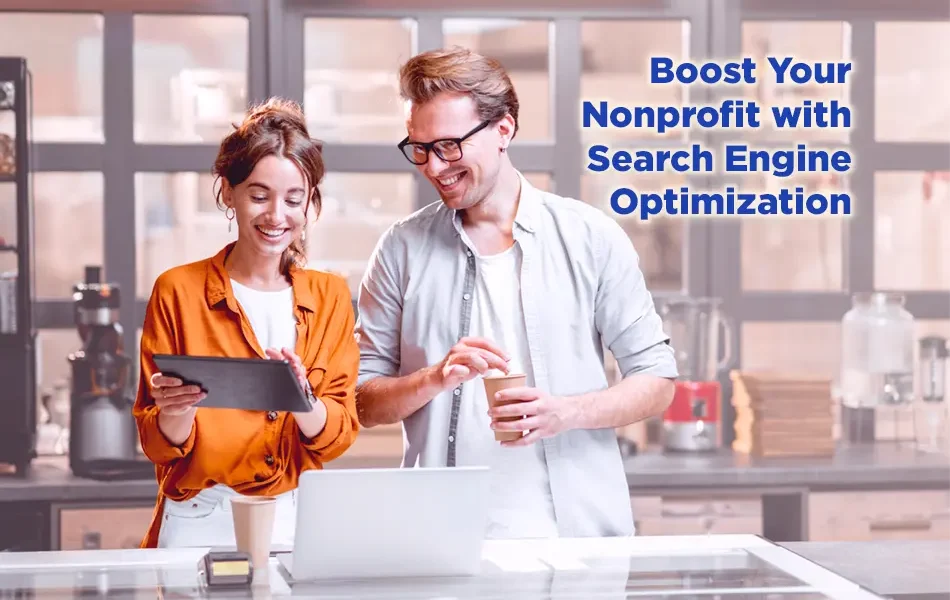 Two colleagues smiling and reviewing content on a tablet and laptop in a modern workspace, with text reading “Boost Your Nonprofit with Search Engine Optimization.”